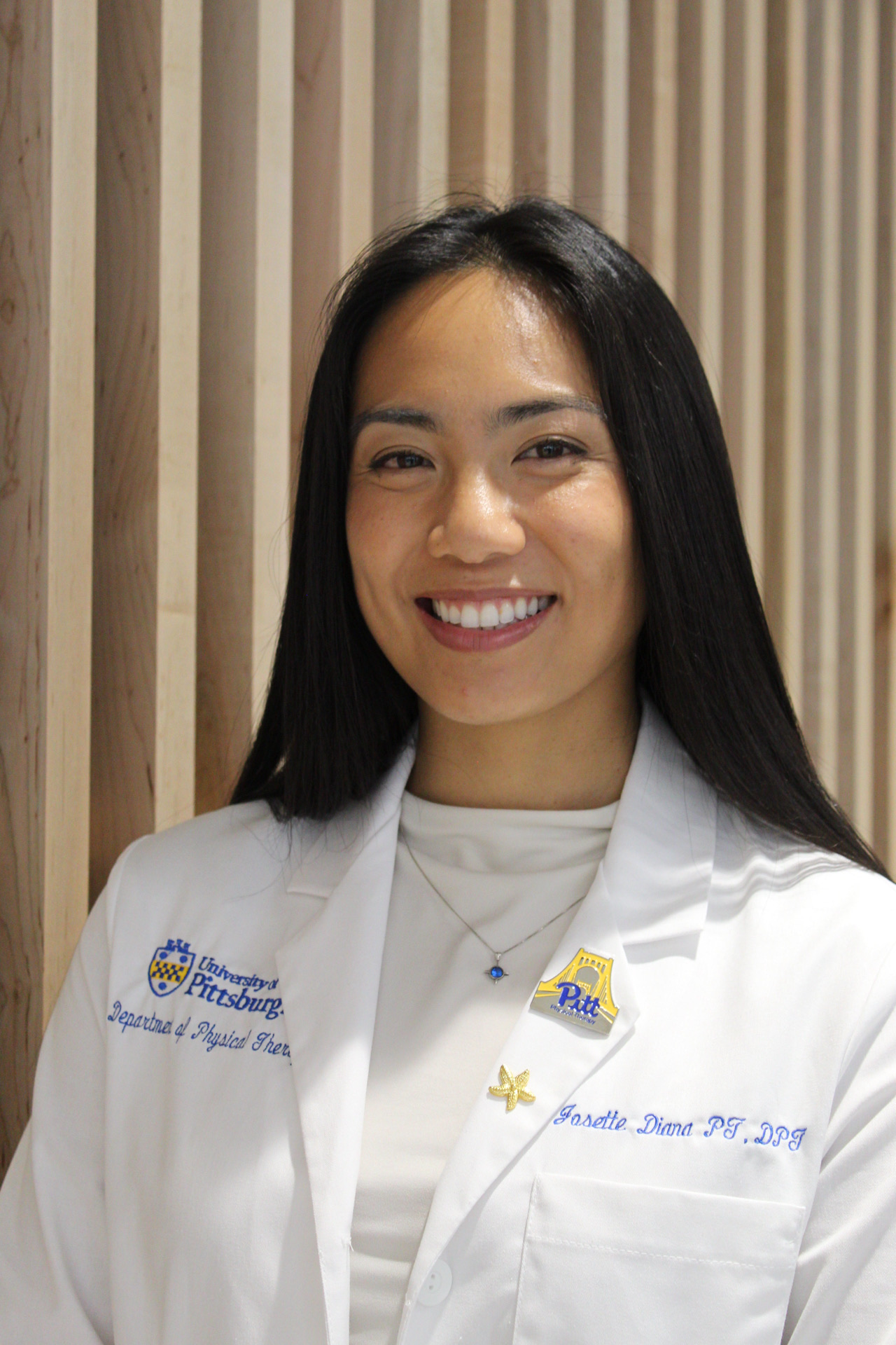 Professional headshot in white coat